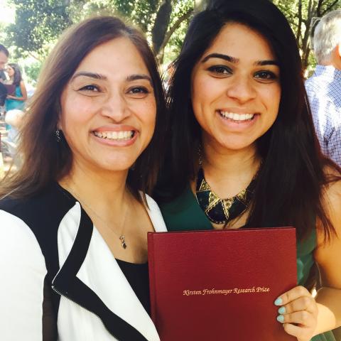 A Stanford University student accepting an award stands next to her mother